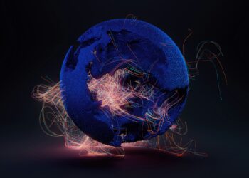 A digital representation of Earth is shown against a dark background. The globe, rendered in a textured, dark-blue mesh and partially fragmented, bursts with bright, colorful lines of light swirling and streaming around it. These vibrant lines suggest connectivity and movement, embodying the dynamic spirit of an NFT. | eCryptoBit