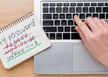 A hand types on a laptop keyboard next to a notepad showing crossed-out weak passwords and a highlighted strong password: "uFree!!!=3", reminding users of tips for avoiding scams on verification-free gambling sites. | eCryptoBit